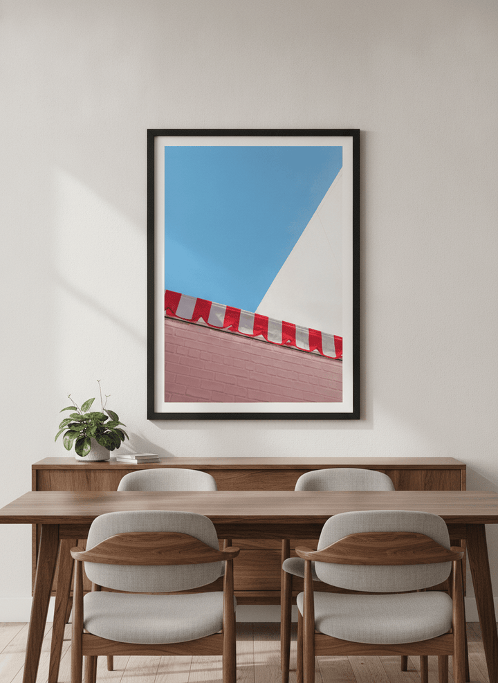 Wall art styled above a dining table in a contemporary home