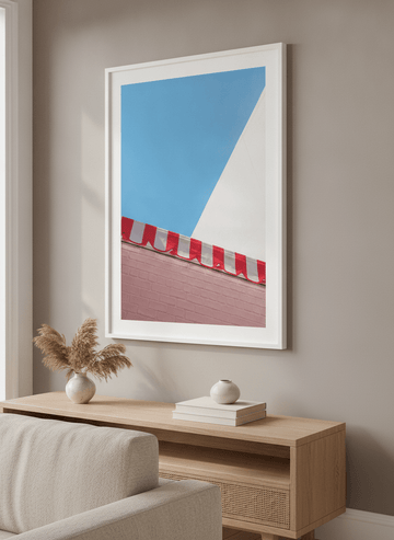 Modern wall art styled above a sofa in a neutral living room