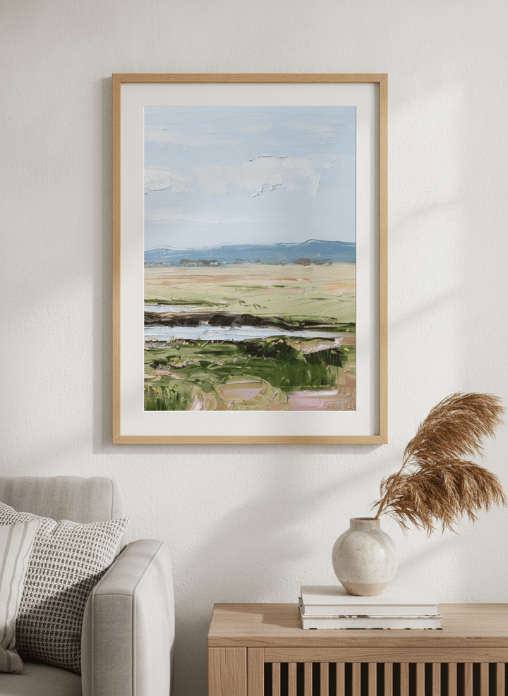 Modern wall art styled above a sofa in a neutral living room