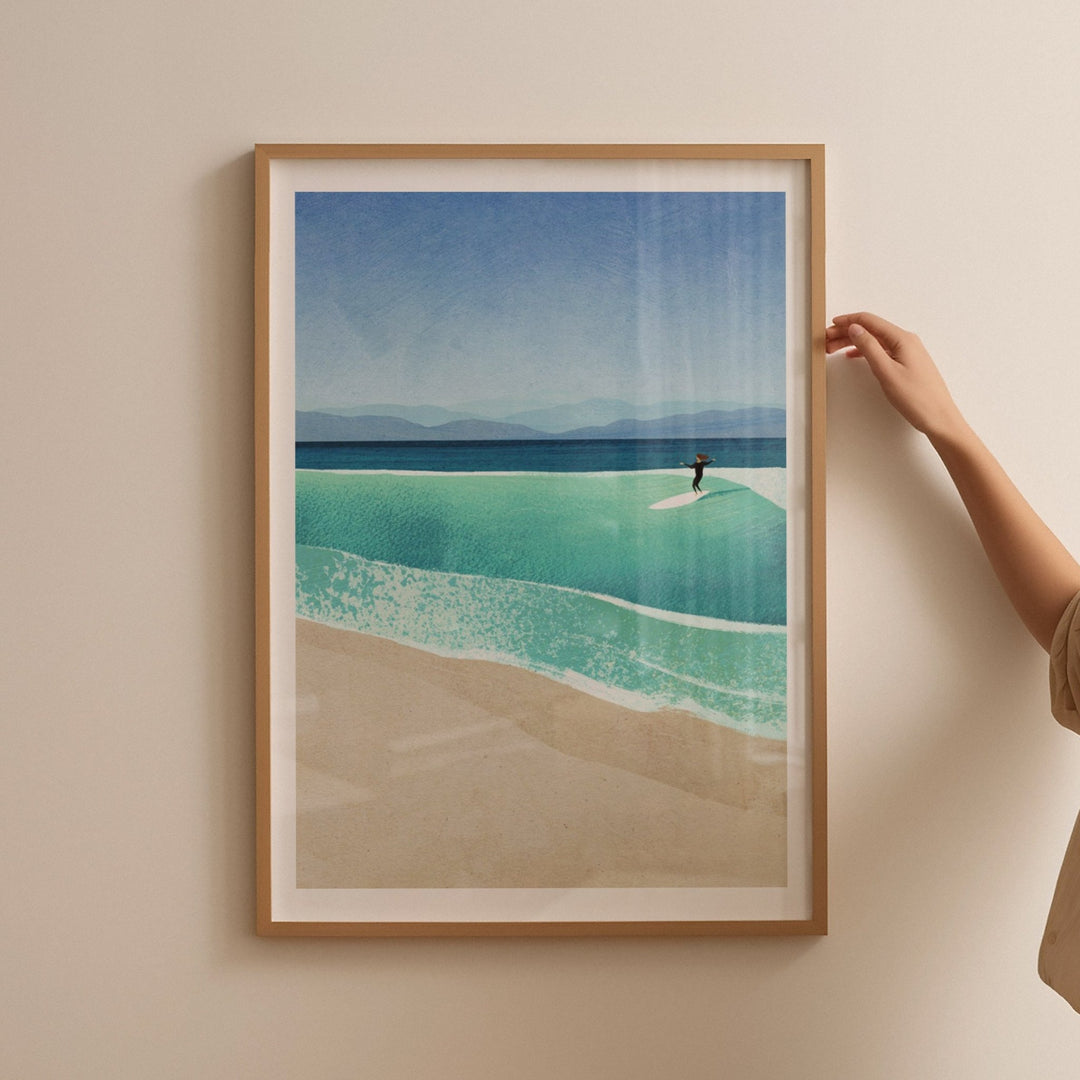 Beach scene with a person on a surfboard, held by a hand against a beige wall.