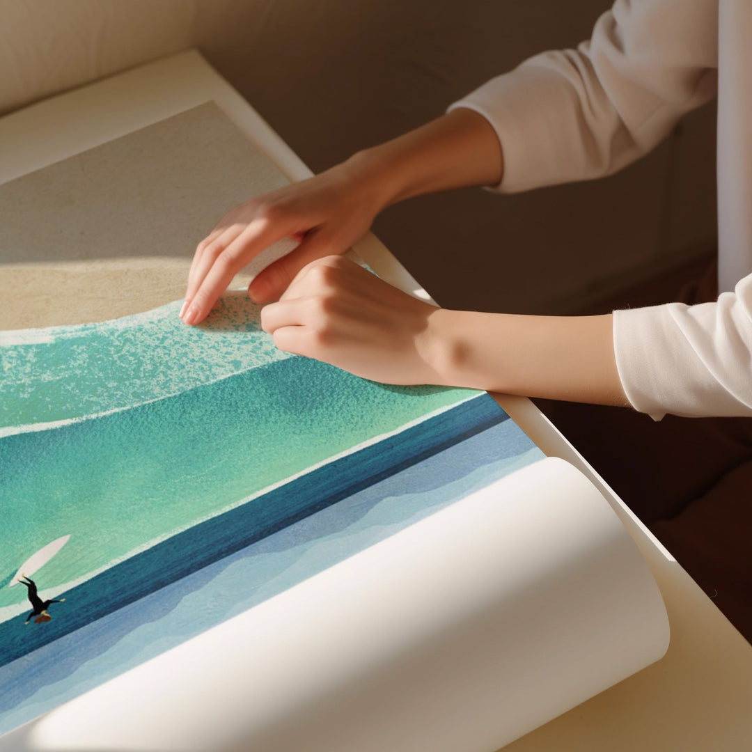 Person unrolling a large piece of paper with a scenic design, possibly an artwork or poster.