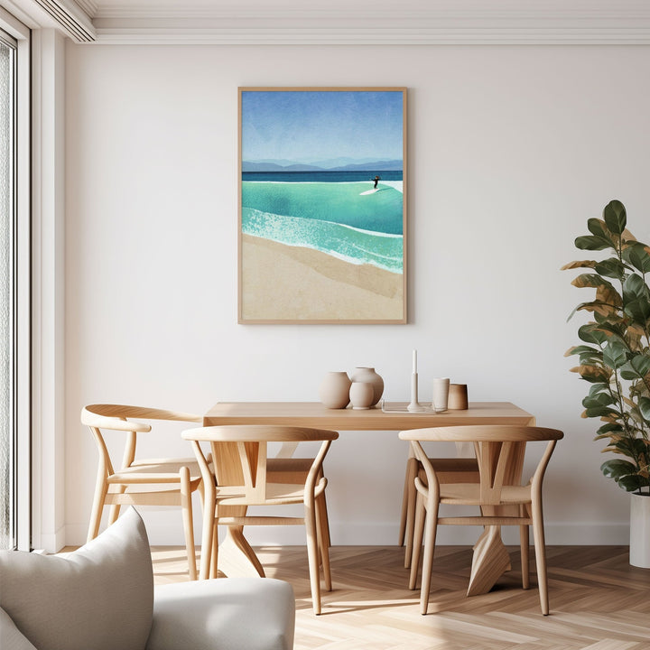 Dining room with wooden table and chairs, beach scene painting on the wall, and plant.
