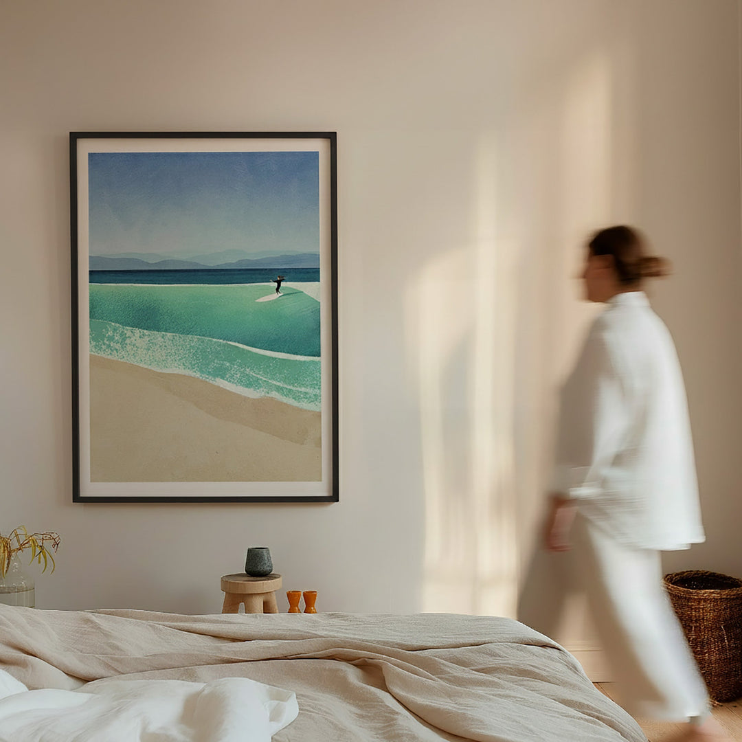 beach scene print on a wall with a person walking in the background