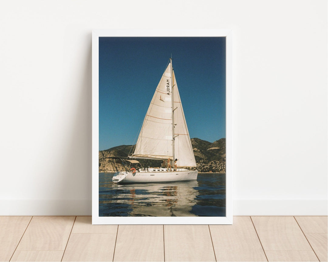 photo of sailboat on floor leaning against white wall