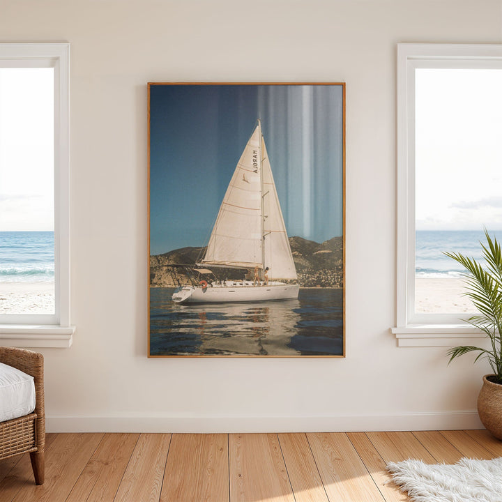 photo of white sailboat on wall in between windows