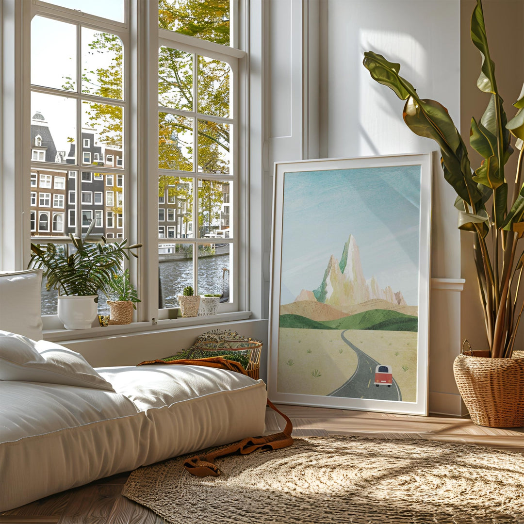 Living room with a large window, artwork, and decorative plants.