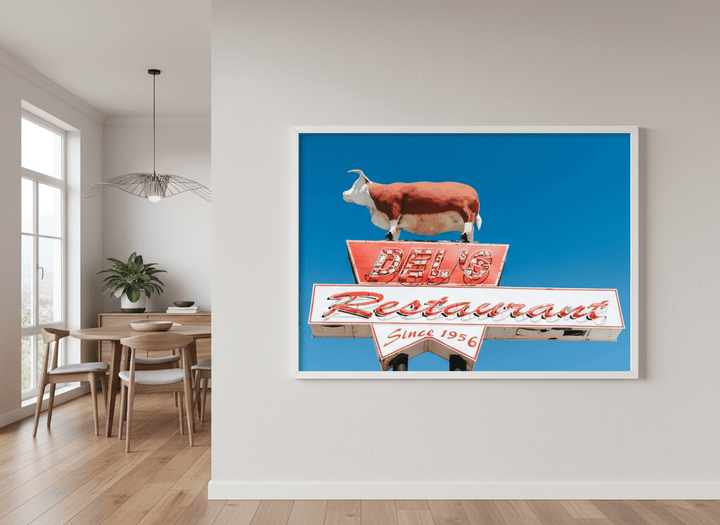 Wall art styled above a dining table in a contemporary home