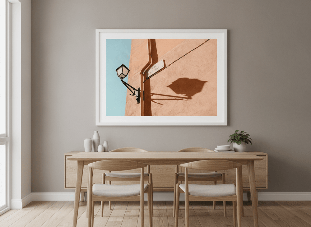Wall art styled above a dining table in a contemporary home