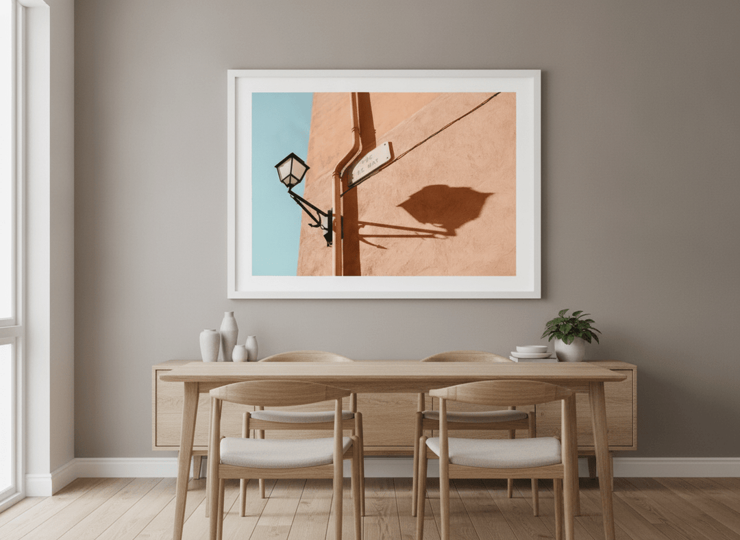Wall art styled above a dining table in a contemporary home
