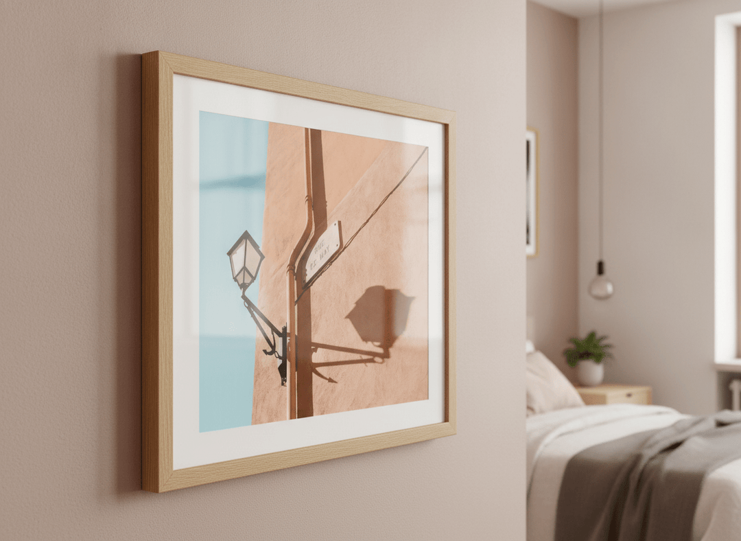 Minimalist artwork displayed in a calm, light-filled bedroom interior