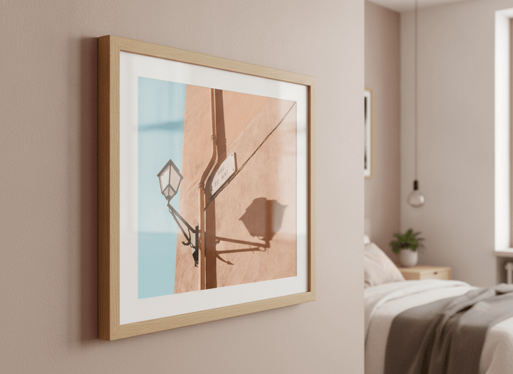 Minimalist artwork displayed in a calm, light-filled bedroom interior