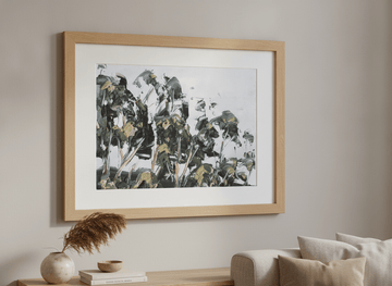 Modern wall art styled above a sofa in a neutral living room
