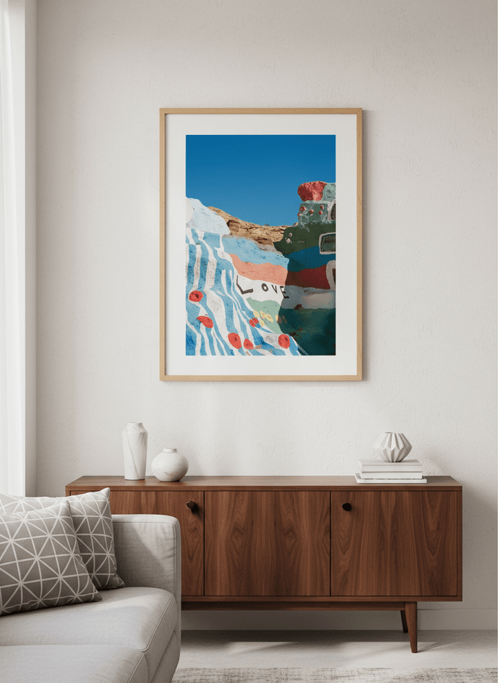 Modern wall art styled above a sofa in a neutral living room