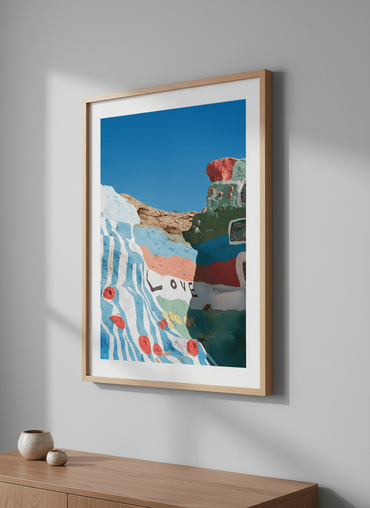 Minimalist artwork displayed in a calm, light-filled bedroom interior
