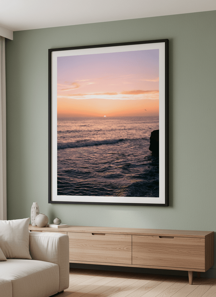 Modern wall art styled above a sofa in a neutral living room