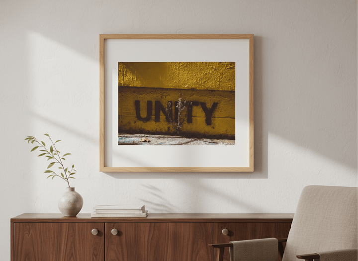 Modern wall art styled above a sofa in a neutral living room
