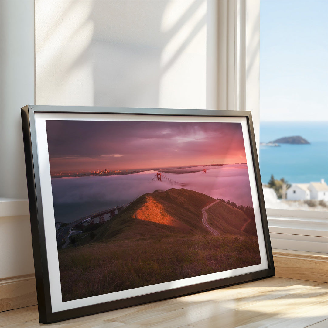 Artwork of a sunset over a landscape with a body of water and a bridge.