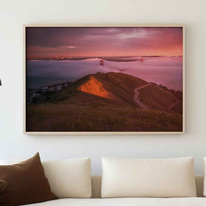 Modern living room with a white sofa, decorative pillows, and a landscape painting on the wall.