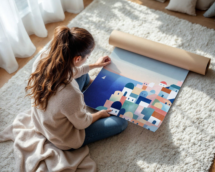 Person unrolling a colorful abstract design on a floor