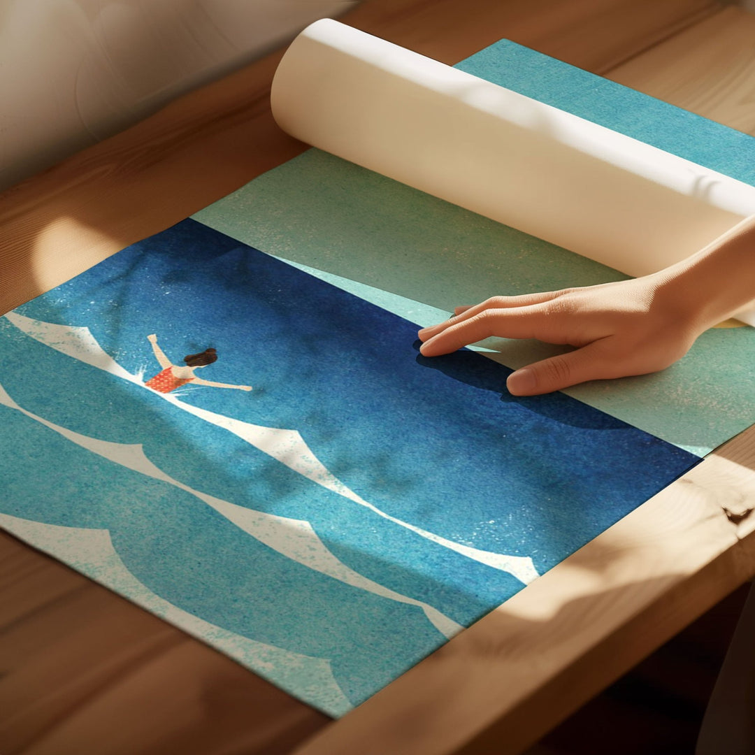 Person unrolling a colorful rug with artistic design on a wooden floor