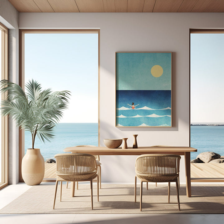 Modern dining room with ocean view, table, chairs, and beach-themed artwork.