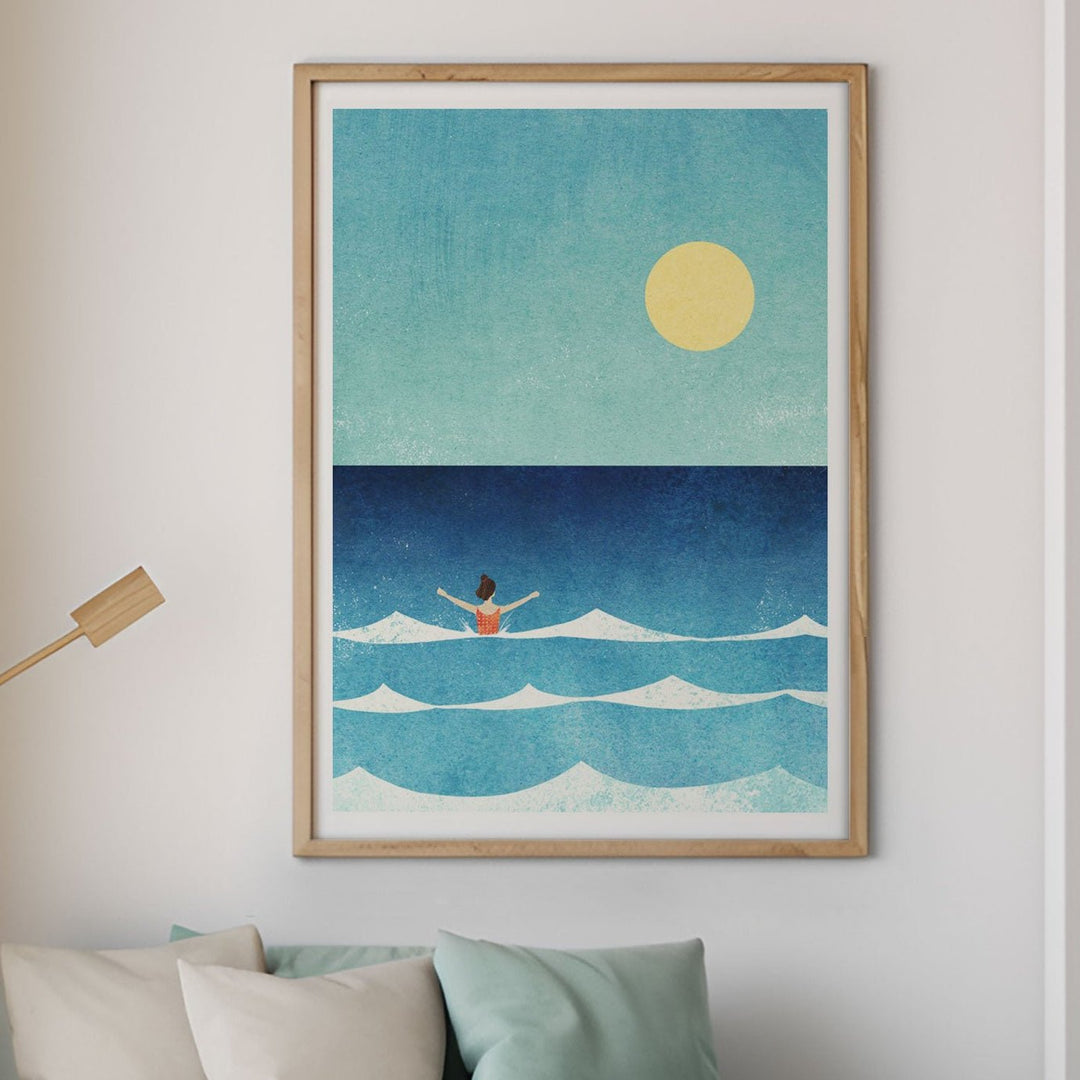 Modern living room with a beach-themed painting, sofa, and armchair.