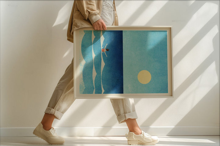 Person holding abstract artwork with blue and green tones.
