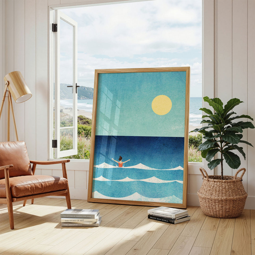 artwork of a beach scene with a person in the ocean, placed in a room with a window view of the sea.