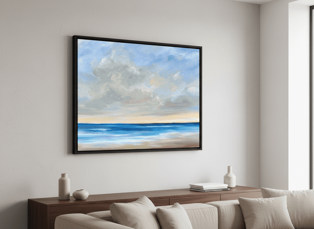 Modern wall art styled above a sofa in a neutral living room