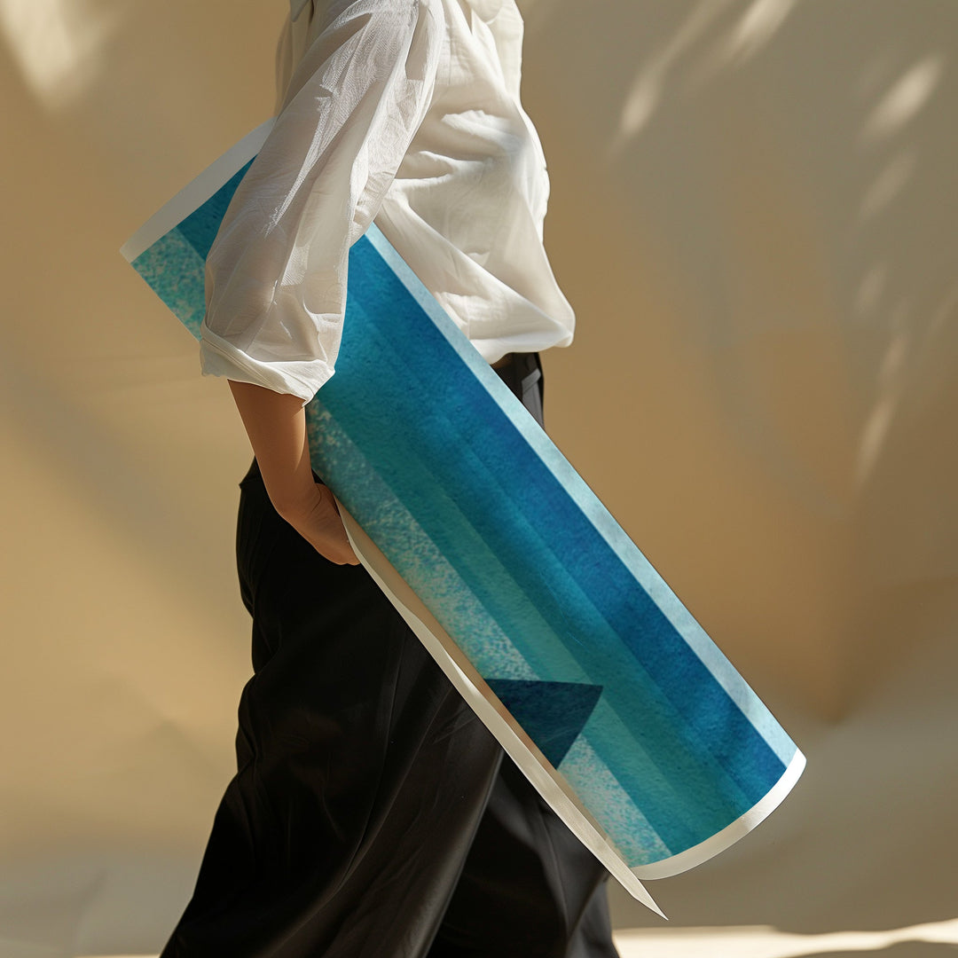 Person holding a blue and white patterned mat against a neutral background