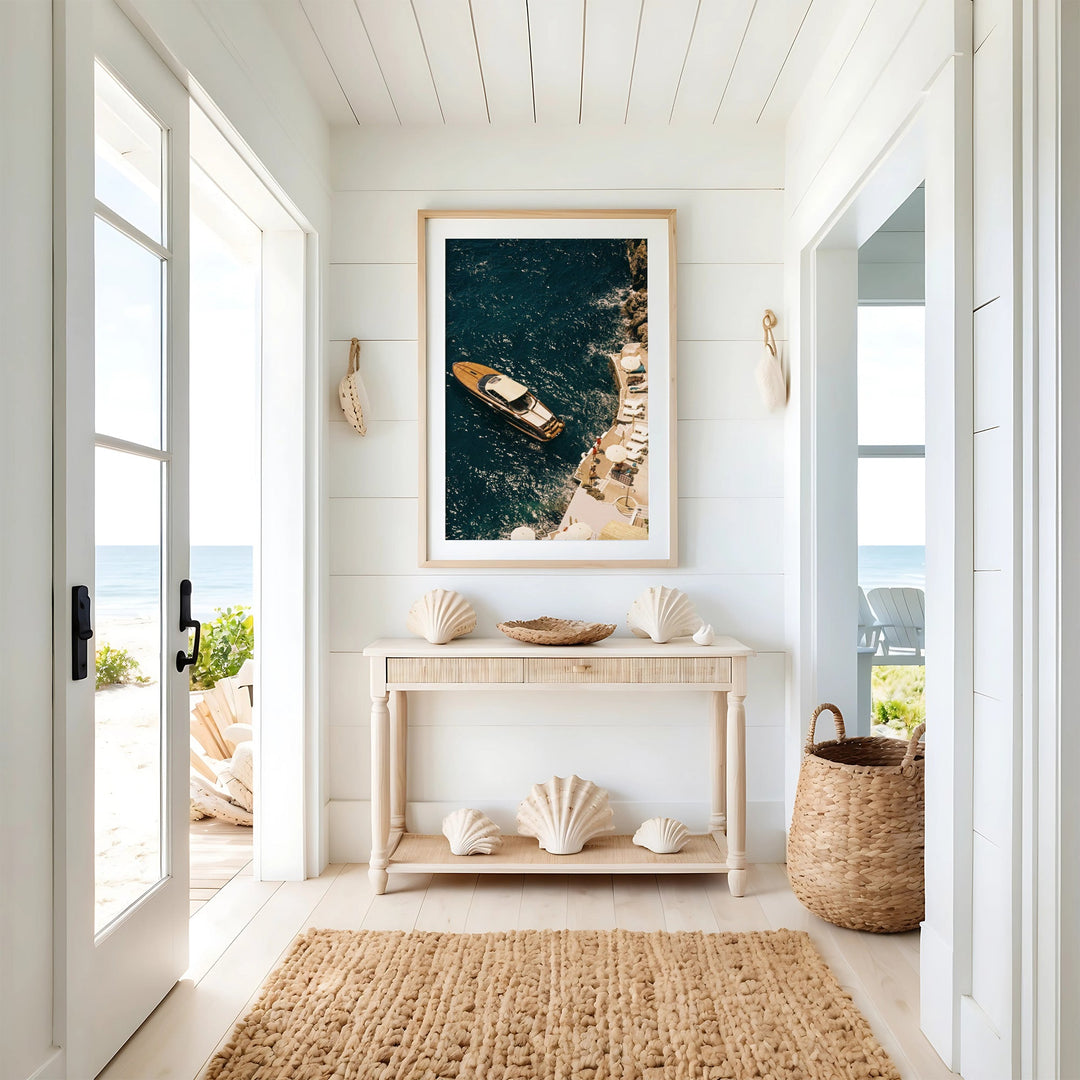 coastal hallway with photo hanged on top of console with shells