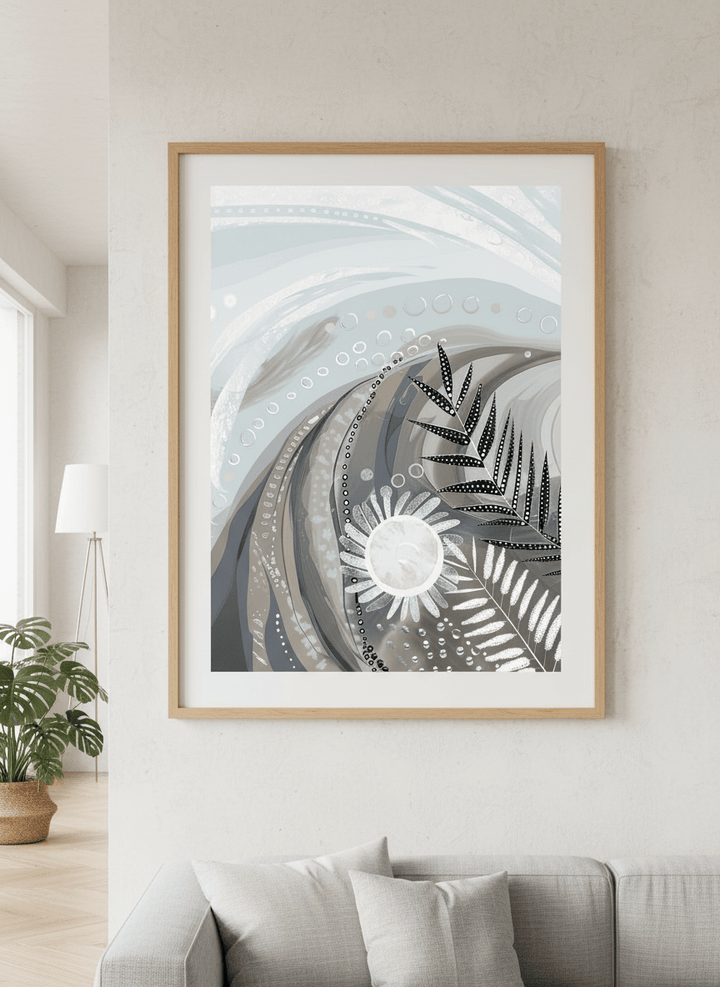 Modern wall art styled above a sofa in a neutral living room