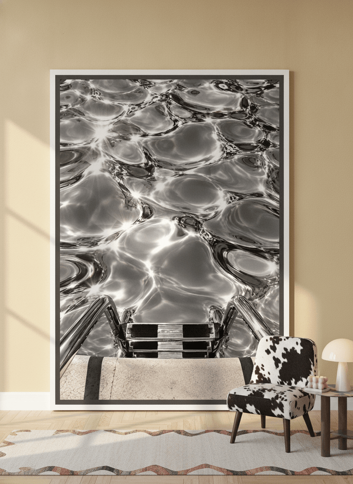 Oversized statement canvas wall art with a white surround leaning against the wall in a colourful eclectic living room
