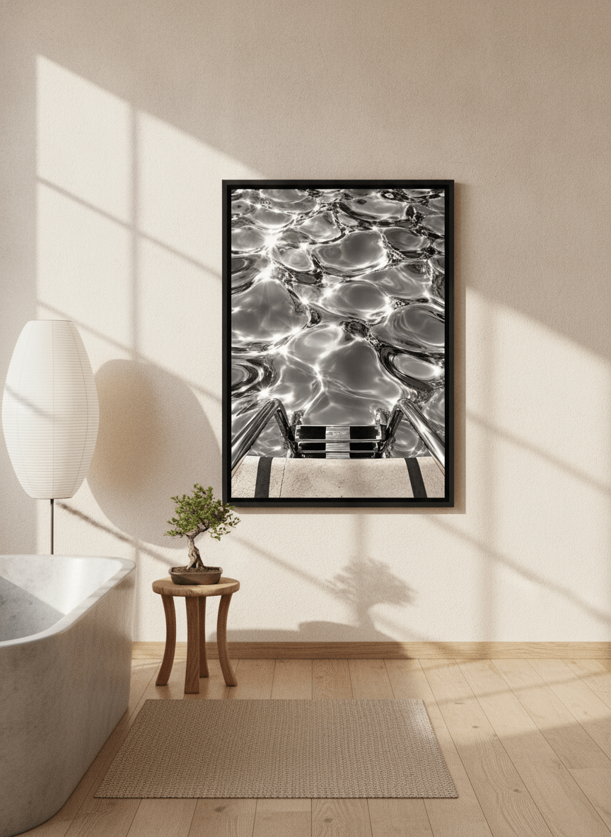Canvas wall art with a black surround styled on the wall in a warm Japandi bathroom