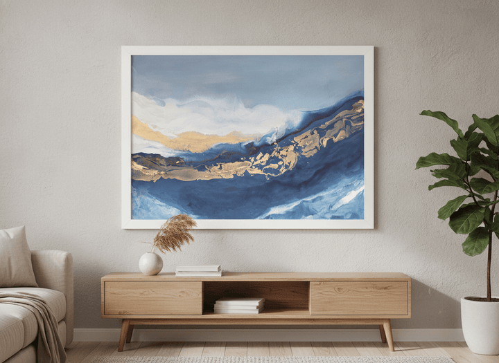 Modern wall art styled above a sofa in a neutral living room