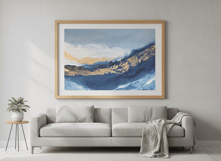 Modern wall art styled above a sofa in a neutral living room