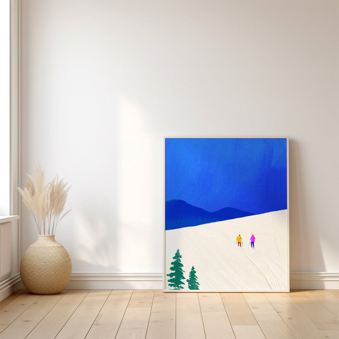 Artwork of two figures and trees on a blue and white background, placed on a wooden floor with a vase.