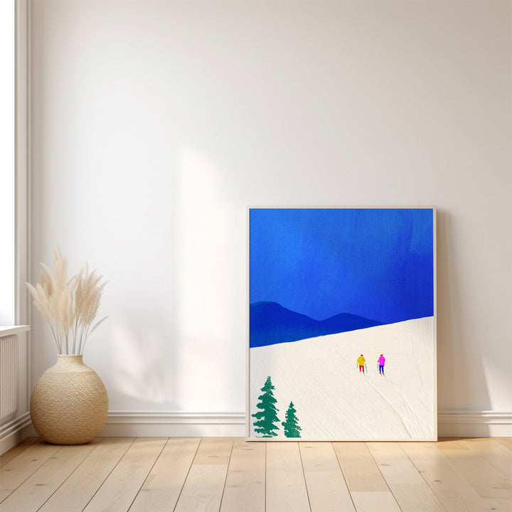 Artwork of two figures and trees on a blue and white background, placed on a wooden floor with a vase.