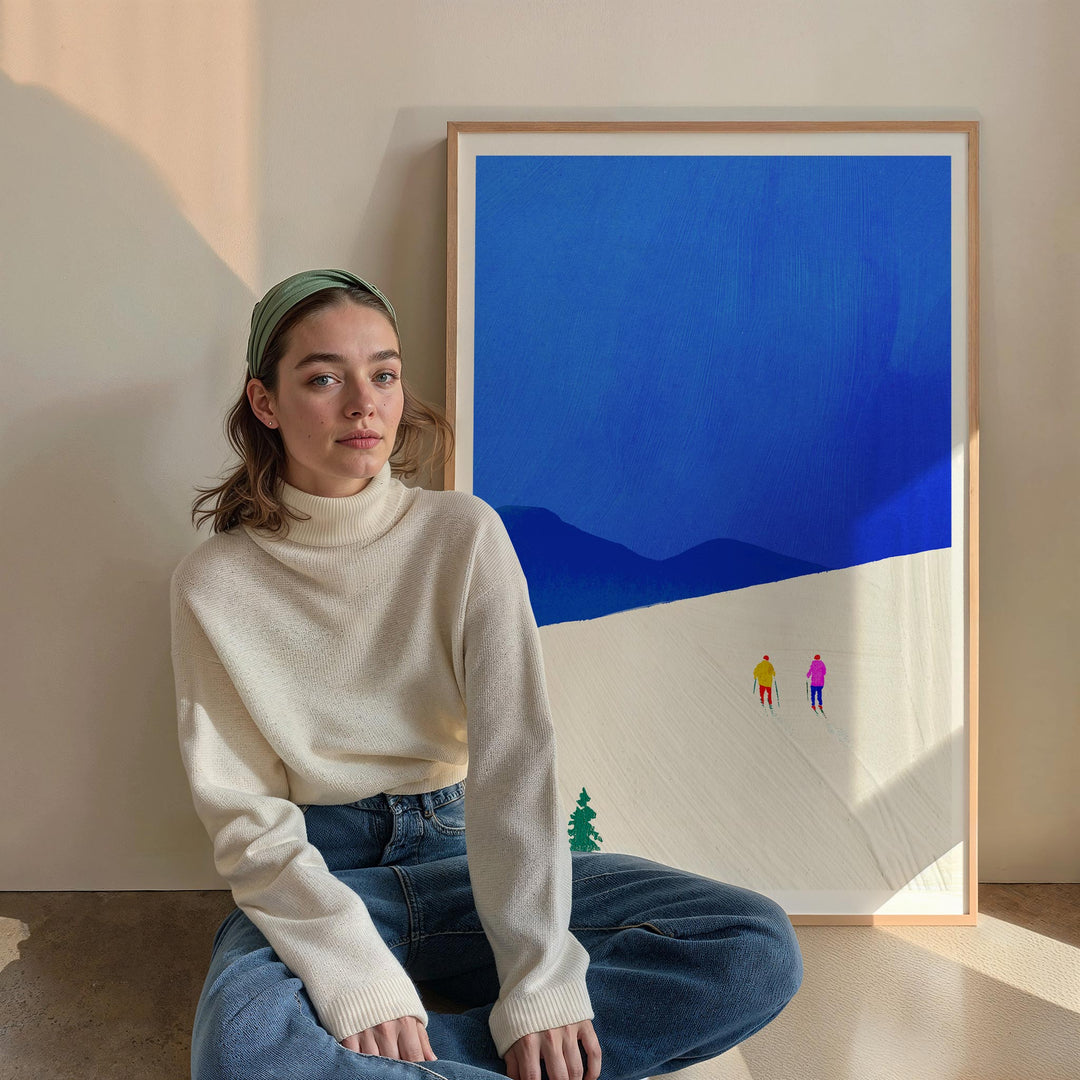 Woman sitting in a room with a blue abstract painting on the wall