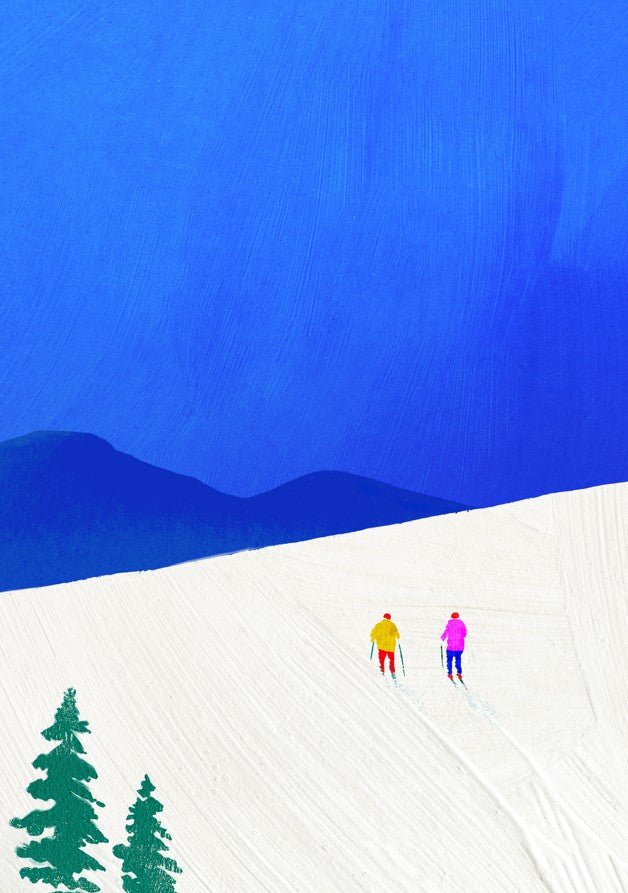 Two people walking on a snowy landscape with a blue sky and trees. framed