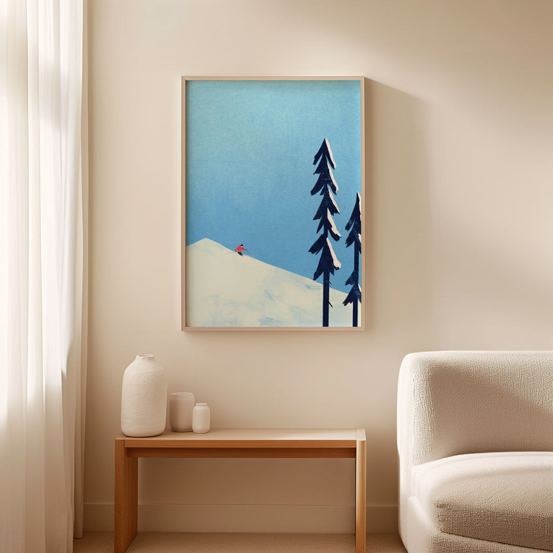 Artwork of trees and a mountain on a wall above a table with decorative items.