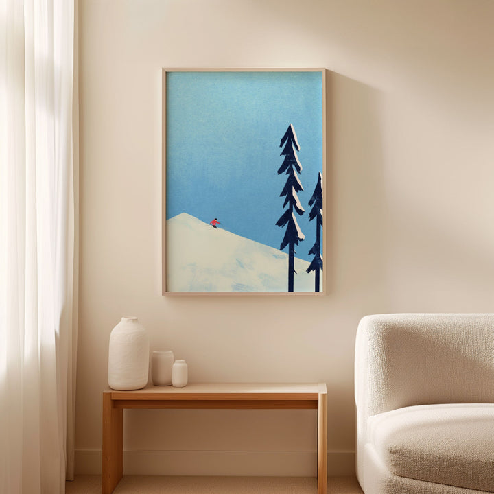 Artwork of trees and a mountain on a wall above a table with decorative items.