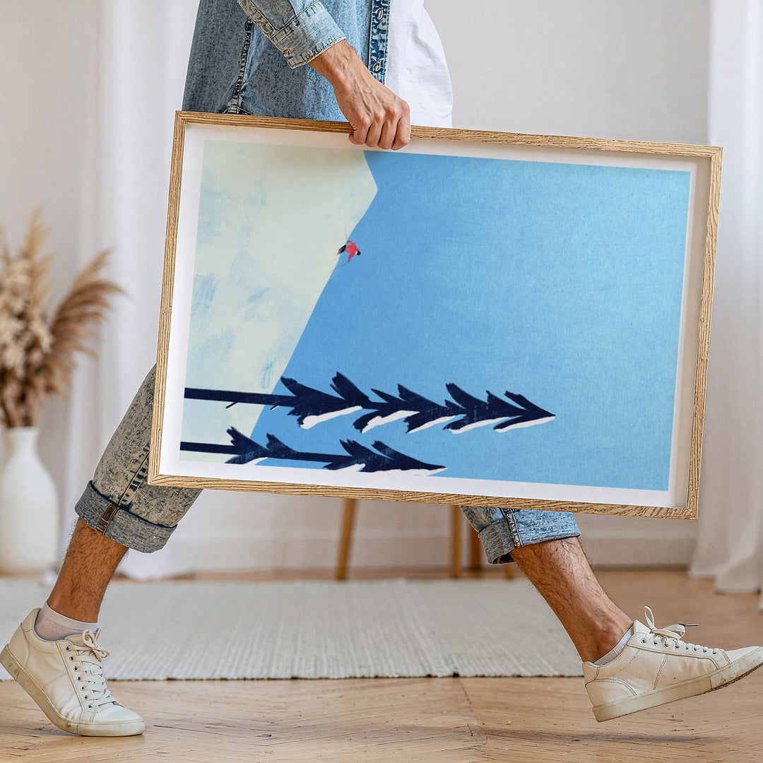 Person holding an artwork with abstract design in a room.