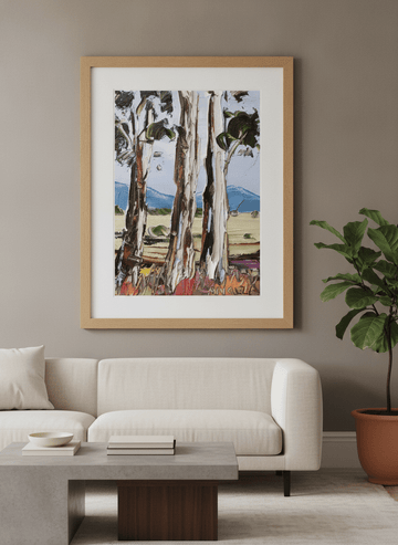 Modern wall art styled above a sofa in a neutral living room