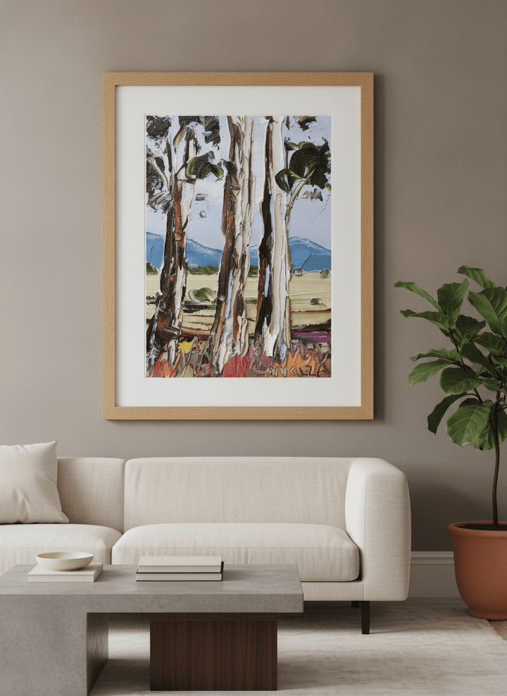 Modern wall art styled above a sofa in a neutral living room