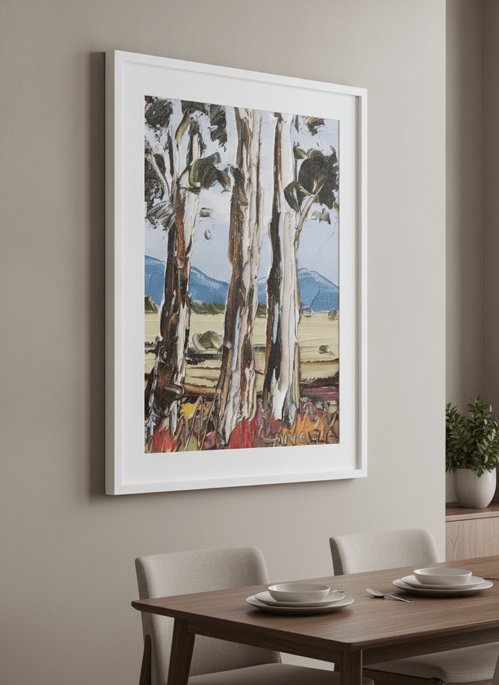 Wall art styled above a dining table in a contemporary home