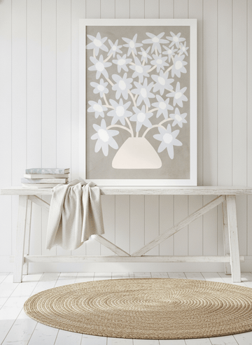 Modern wall art print standing on a console in a coastal dining room