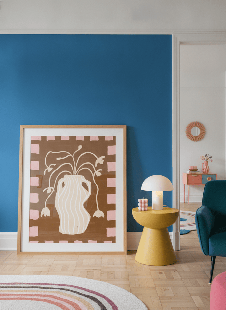 Oversized statement modern wall art print leaning against the wall in a colourful eclectic living room