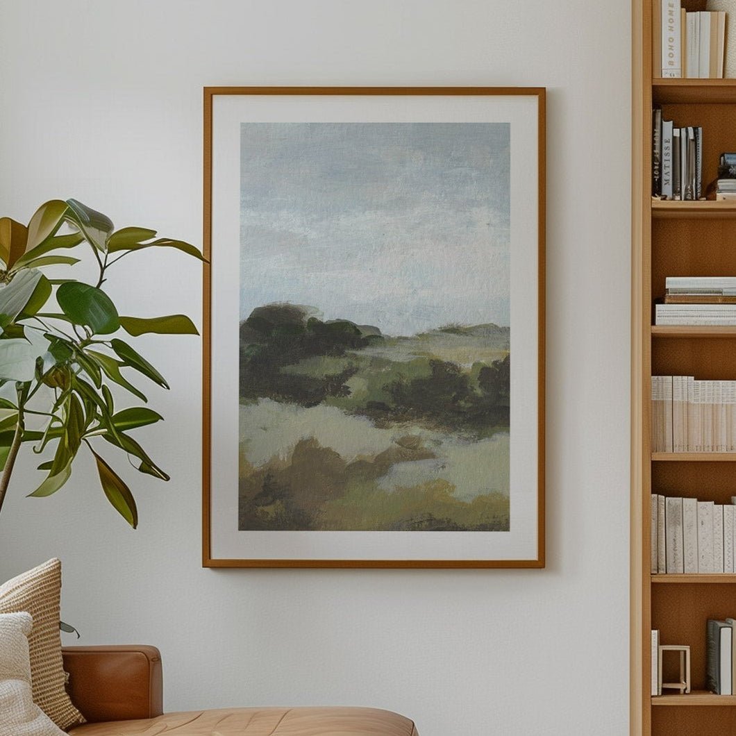 Modern living room with a brown leather sofa, bookshelf, and artwork.