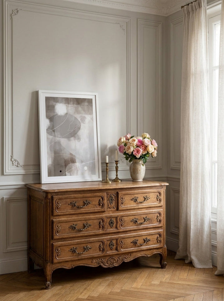 Modern wall art print standing on a sideboard in a Parisian bedroom